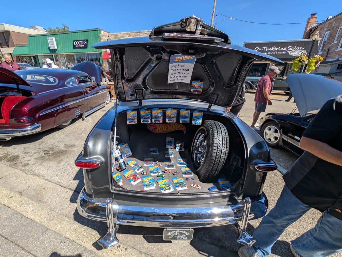 Classic car trunk filled with Hot Wheels collection